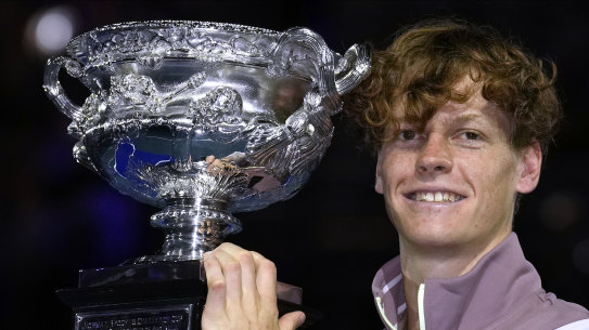 Jannik Sinner holds his Australian Open trophy.