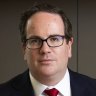 Veterans’ Affairs Minister Matt Keogh with the new simplified laws for veterans compensation compared with old laws.