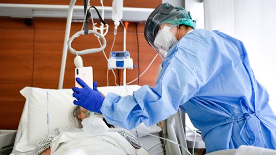 A medical staffer with a COVID-19 patient in Bergamo Hospital, northern Italy.