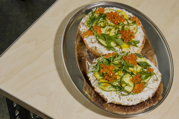 Smoked trout quark, pickled zucchini and salmon roe tartine bagel.