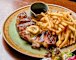 Steak with anchovy-and-confit-garlic butter and bottomless fries at Allegro.