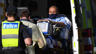 Carlos Bernardes is taken away in an ambulance from The View Hotel Melbourne where Australian Open tennis players are in quarantine.