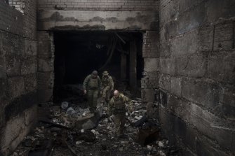 Ukrainian soldiers walk in a building previously used by Russian soldiers as a temporary base in Malaya Rohan, on the outskirts of Kharkiv, Ukraine, Tuesday, April 12, 2022. (AP Photo/Felipe Dana) .
