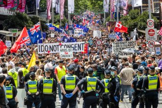 Police look on as protesters gather in Melbourne's CBD.