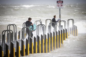 Keen surfers set out from Olivers Hill boat ramp in Frankston during the wild storm on Friday.    Photograph by Paul Jeffers  The Age NEWS  29 Oct 2021