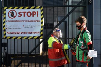 Football fans pass through the security checkpoint before the Irish Cup Final at Windsor Park in Belfast, Northern Ireland. The Irish Cup final is the first sporting event in the UK to allow spectators to return. 
