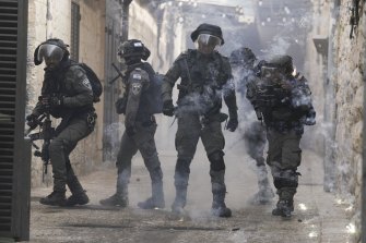 Palestinians shoot fireworks at Israeli police in the Old City of Jerusalem on Sunday.