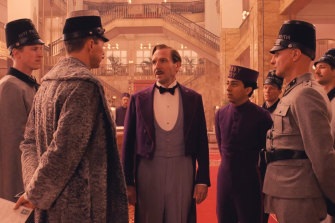 Ralph Fiennes, centre, amid the shabby glamour of The Grand Budapest Hotel.