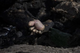Charred bodies of five people, lie on the ground in Bucha, on the outskirts of Kyiv, Ukraine, on Monday.