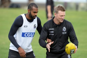 Heritier Lumumba, left, with Nathan Buckley, right, at a Collingwood training session in 2014.