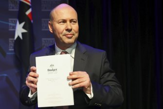 Treasurer Josh Frydenberg with the 2021-22 budget. Elements of that budget, and of last year’s mid-year update, are yet to be passed into law.