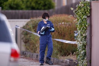 Police and forensic experts investigate after a woman and child were found dead in a house in Pascoe Vale.