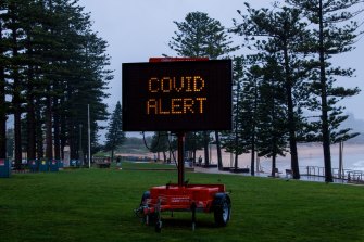 A COVID alert sign at Sydney's Dee Why beach.