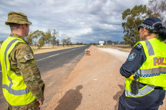 A soldier and police officer patrol Queensland's border with NSW near Hebel in central-southern Queensland before ADF personnel were withdrawn in September.