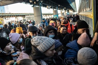 Ukrainians seeking to leave Kyiv board a train shortly after President Vladimir Putin put Russia on nuclear alert.