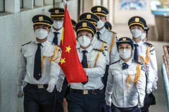 Students march with a Chinese national flag during a flag-raising ceremony to mark the 25th anniversary of Hong Kong’s return to Chinese rule at Scientia Secondary School in Hong Kong on Thursday.