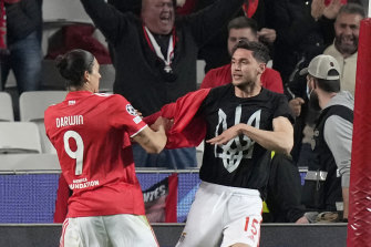 Benfica’s Darwin Nunez (left) helps teammate Roman Yaremchuk, from Ukraine, take off his shirt after scoring his side’s second goal, to reveal an undershirt with the coat of arms of Ukraine.