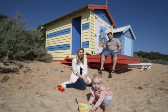 Jenna  and Matthew Graham with their children, Angus and Estelle, outside their bathing box at Brighton beach.