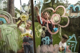 Daniela Minns, artist, blogger and parent of three, paints with, Celeste, 11 and Hugo, 8, coloured shaving cream on their glass sliding doors at home. She has recently written a post on ’101 activities to occupy your kids in lockdown’.