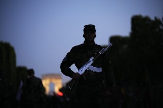 Bulgarian soldiers stand on the Champs-Élysées during a rehearsal for the Bastille Day parade in Paris.