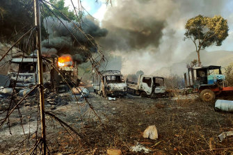In this photo provided by the Karenni Nationalities Defense Force, smokes and flames billow from vehicles in Hpruso township, Kayah state, in which people were shot and burnt on December 24.