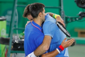 Juan Martin del Potro cries while hugging Novak Djokovic after defeating him. 