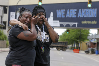 Sandra Dees, left, and Marquita Carter cry in front of the Harold K. Stubbs Justice Center, Sunday, July 3, 2022, in Akron, Ohio, after viewing the body cam footage of Jayland Walker’s fatal shooting by Akron Police.