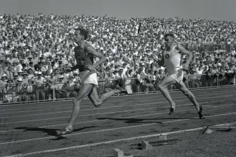 John Landy leads Merv Lincoln in the third lap of the mile race where he managed another time below four minutes at Olympic Park.