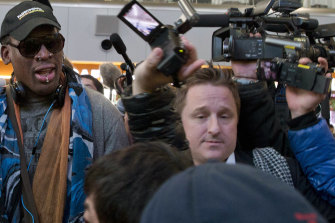 Michael Spavor, centre, is seen with former NBA star Dennis Rodman, left, at Beijing airport in 2013, before a flight to North Korea. 