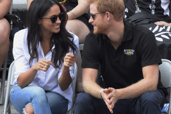 Meghan sporting ripped jeans and a white shirt at the Invictus Games in 2017.
