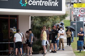 People outside a Centrelink office early in the pandemic recession. There were major benefits to low-income earners from the success of government and Reserve Bank policy.