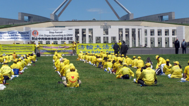 Falun Gong practitioners demonstrate outside the Australian Parliament House in Canberra in 2016.