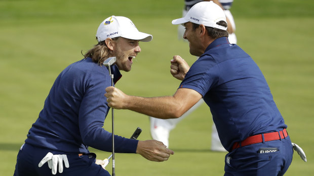 Europe's Francesco Molinari, right, and Tommy Fleetwood win a hole in their fourball match.