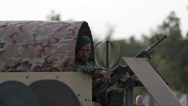 A National Army soldier stands guard near a deadly attack outside the Rural Rehabilitation and Development Ministry in Kabul, Afghanistan, Sunday, July 15, 2018