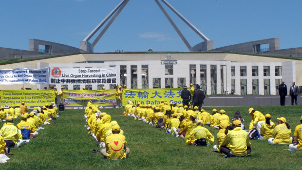 Falun Gong practitioners demonstrate outside Australia's Parliament House in Canberra in 2016.