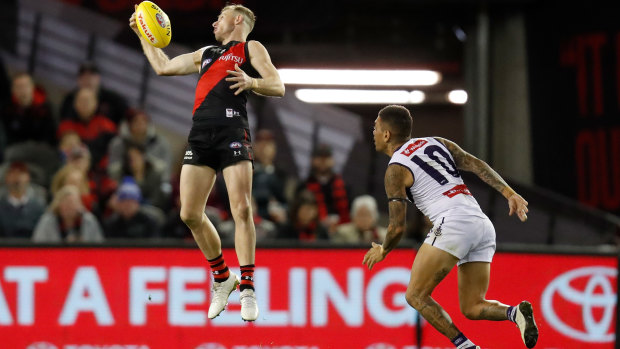 Nick Hind takes a stellar mark against Michael Walters and the Dockers at Marvel Stadium.