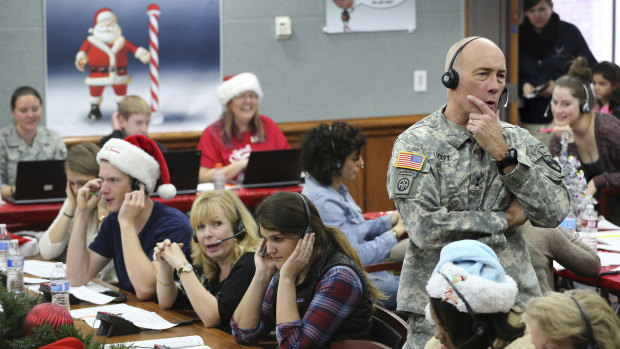 Hundreds of volunteers help answer the phone calls from children around the world as NORAD tracks Santa.