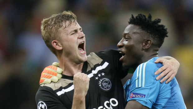 Sweet victory: Ajax's Andre Onana, right, and Maximilian Wober celebrate at the final whistle.