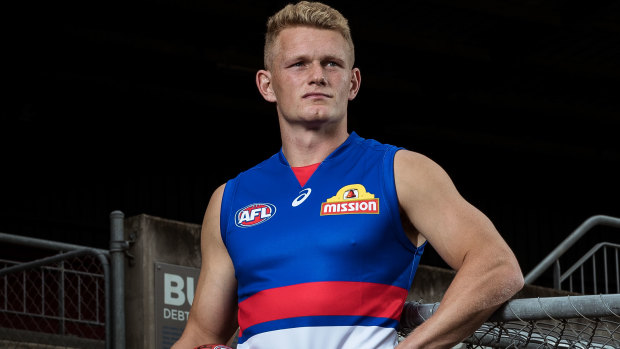 Adam Treloar tries out his new jersey. 