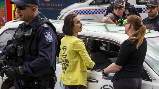 Extinction Rebellion activist Eric Herbert (centre) protests outside government headquarters on Thursday.