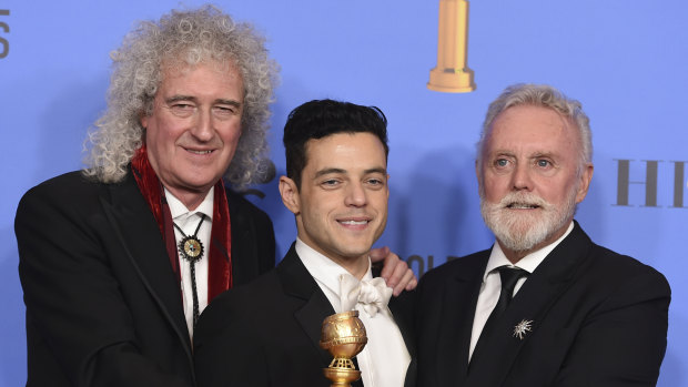 Brian May, left, and Roger Taylor, right, of Queen, and Rami Malek pose with the Golden Globe for Best Motion Picture, Drama for Bohemian Rhapsody. 