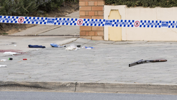 A shotgun lying on a Queanbeyan street where an armed man was shot by police on Saturday morning.