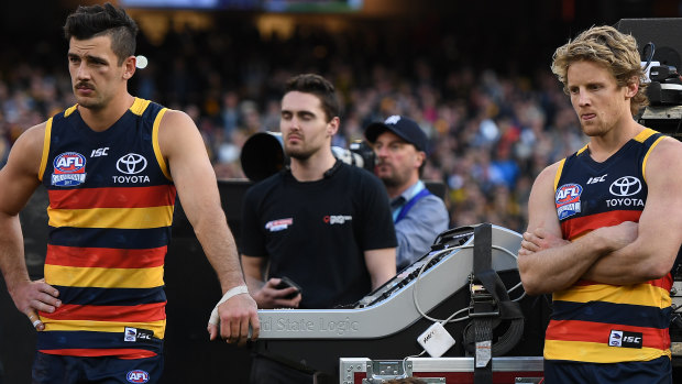 Taylor Walker (left) and Rory Sloane in the immediate aftermath of a losing grand final.