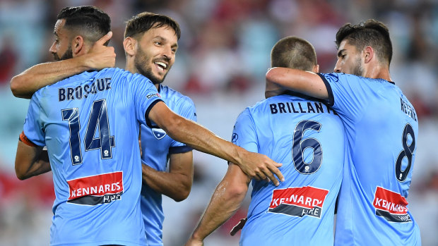 Back in the hunt: Alex Brosque celebrates with teammates after levelling the scores. 