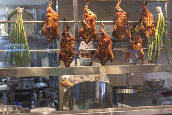 A chef chops cabbage at Taste of Shunde restaurant in Hurstville, Sydney on Thursday, January 27, 2022. Photo by Cole Bennetts