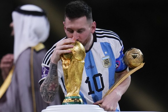 Argentina’s Lionel Messi kisses the trophy as he holds the Golden Ball award for best player of the tournament after winning the World Cup final.