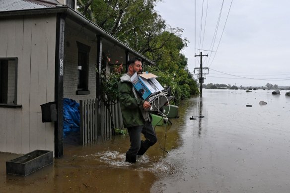Ben Sullivan retrieves a few last items before he leaves his inundated home in Windsor on Monday morning.