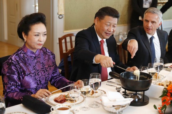 China's President Xi Jinping, centre, his wife Peng Liyuan and Swiss Foreign Minister Didier Burkhalter eat Swiss cheese fondue during lunch. Legal in Switzerland. Illegal in Sunbury.  