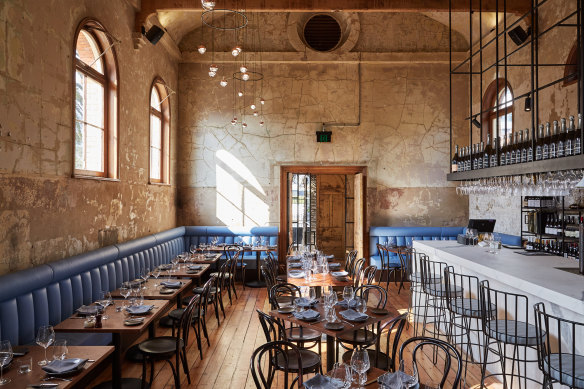 The worn patinated walls and diffused lighting create an intimate setting.