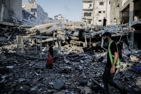 Palestinians inspect damage on Thursday, a day after an Israeli airstrike hit Gaza City.